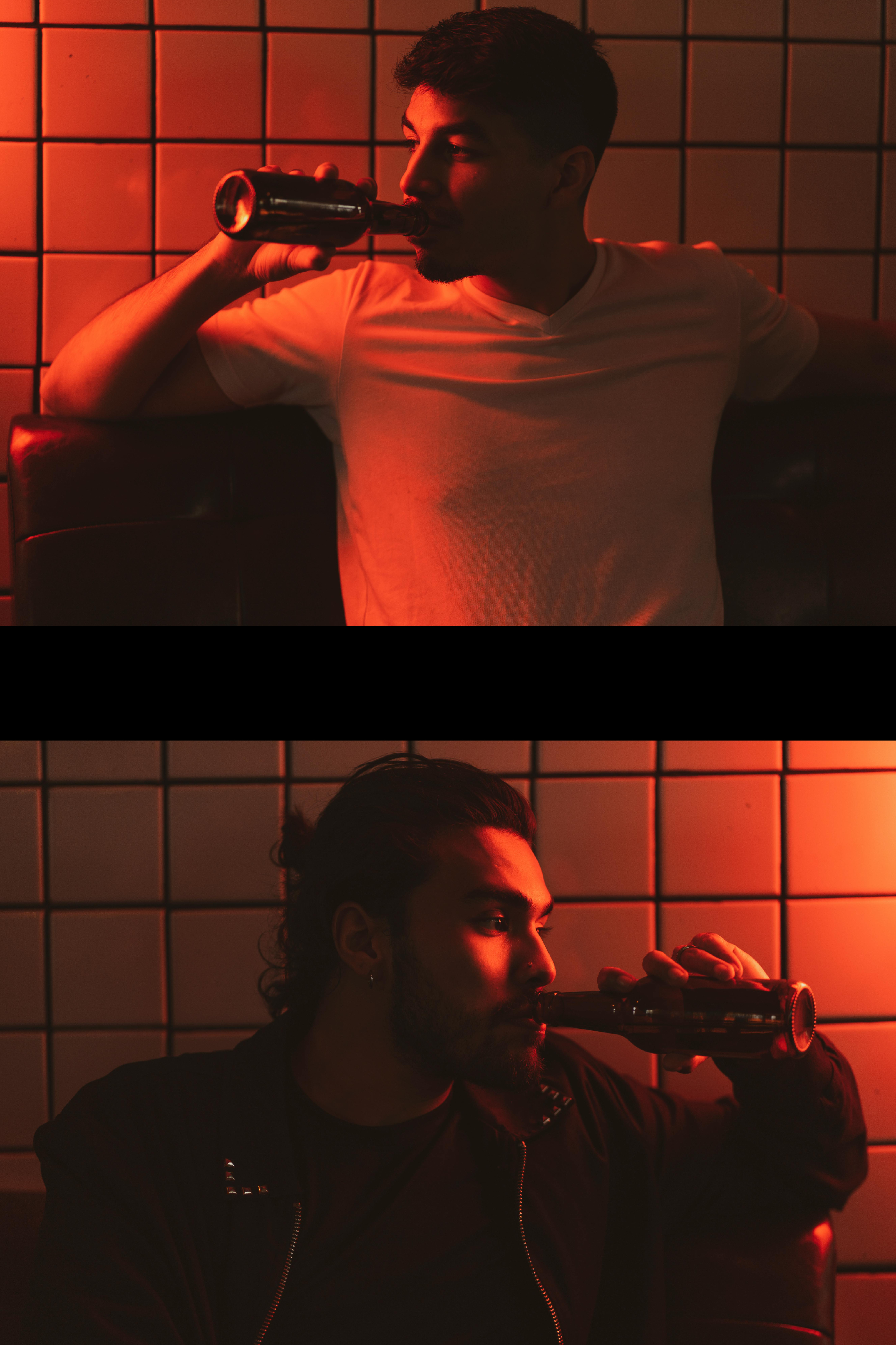 Two men drinking and staring at eachother